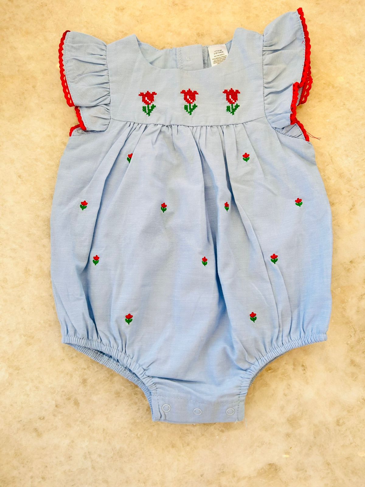 Light blue romper or jumpsuit with red flower embroidery
