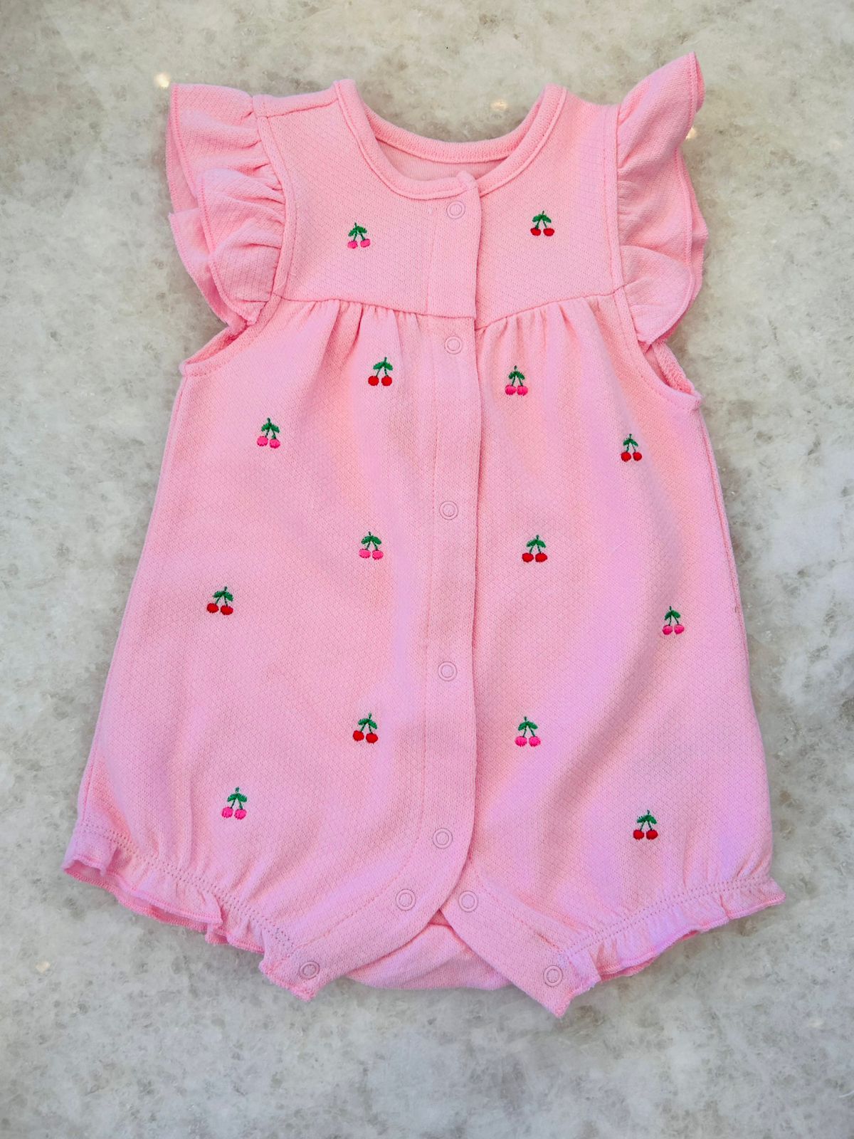 Romper embroidered cherries in pink with ruffled sleeves