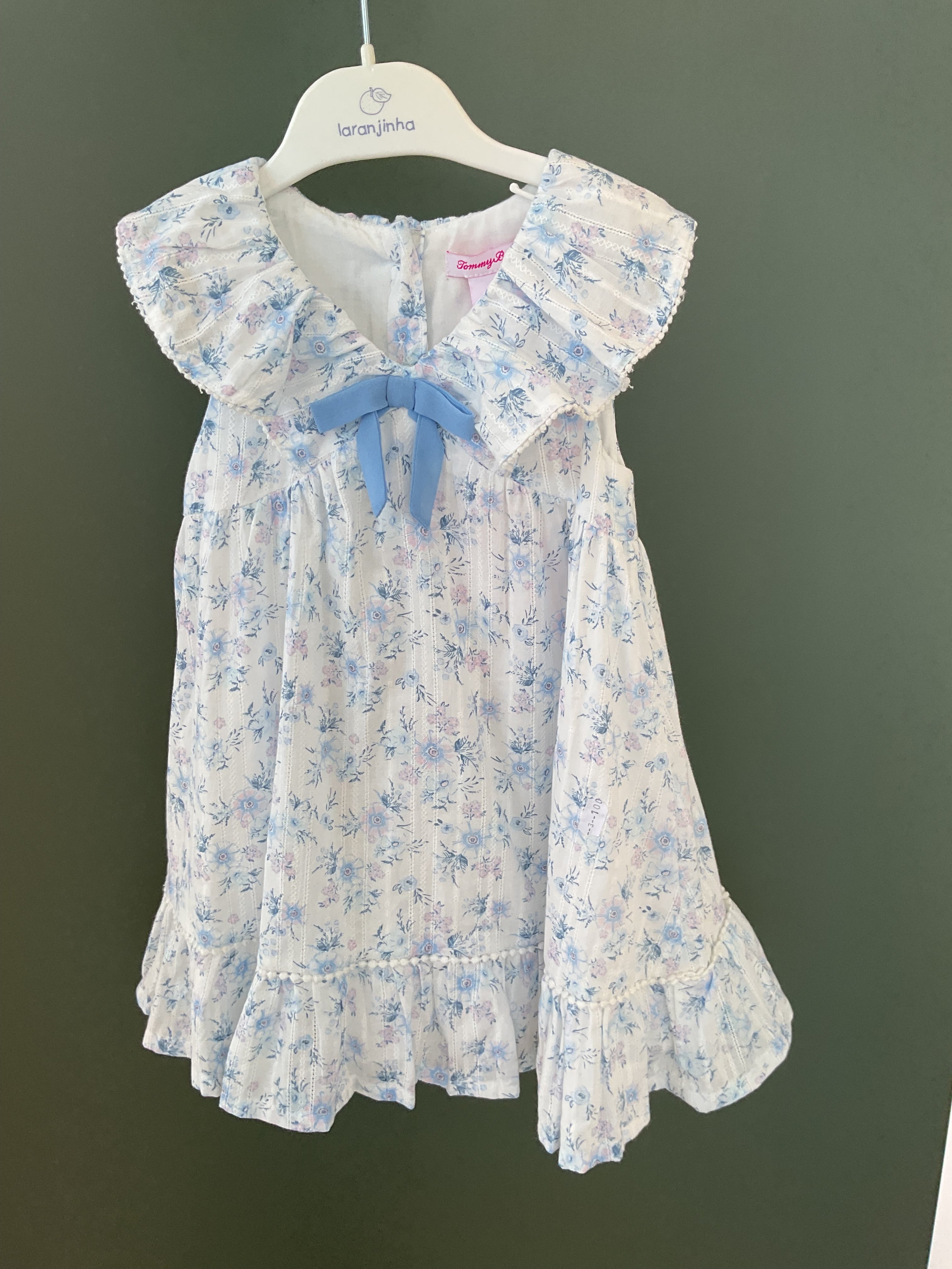 dress featuring a white and blue floral print on what appears to be plumeti cotton fabric.
